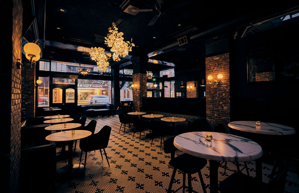 The Harlequin - Great Room with golden chandeliers